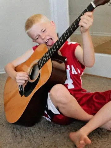 Young Ash Stu with guitar